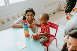 Child playing with a teacher in a classroom