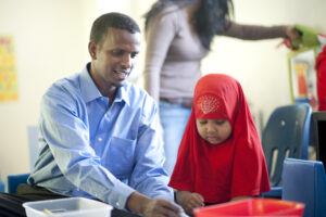 Teacher interacts with a child in a classroom